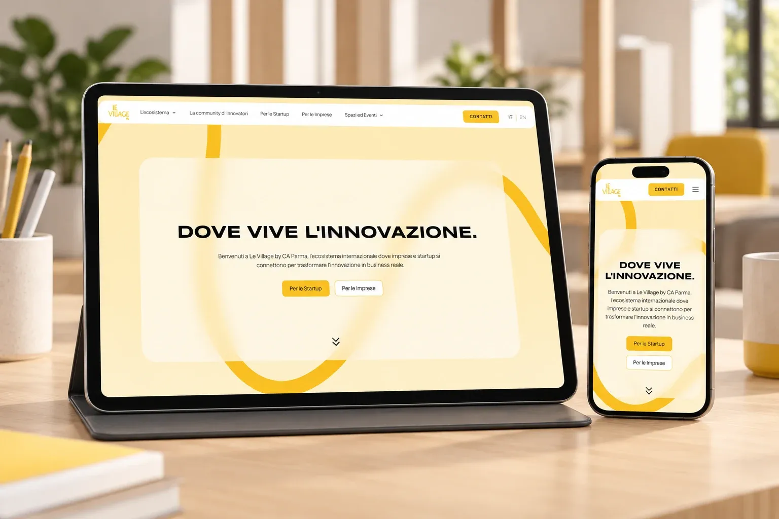 Le Village by CA Parma website home page on an iPad and an iPhone