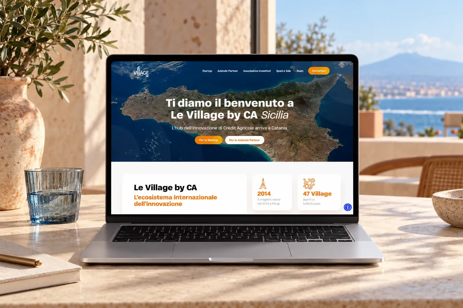Le Village by CA Sicilia website home page on a MacBook Pro